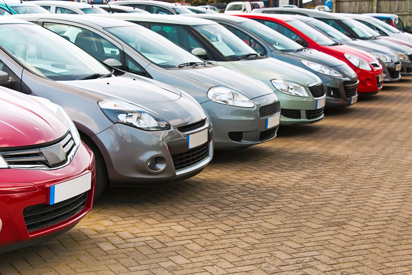 photo of many cars parked in a line