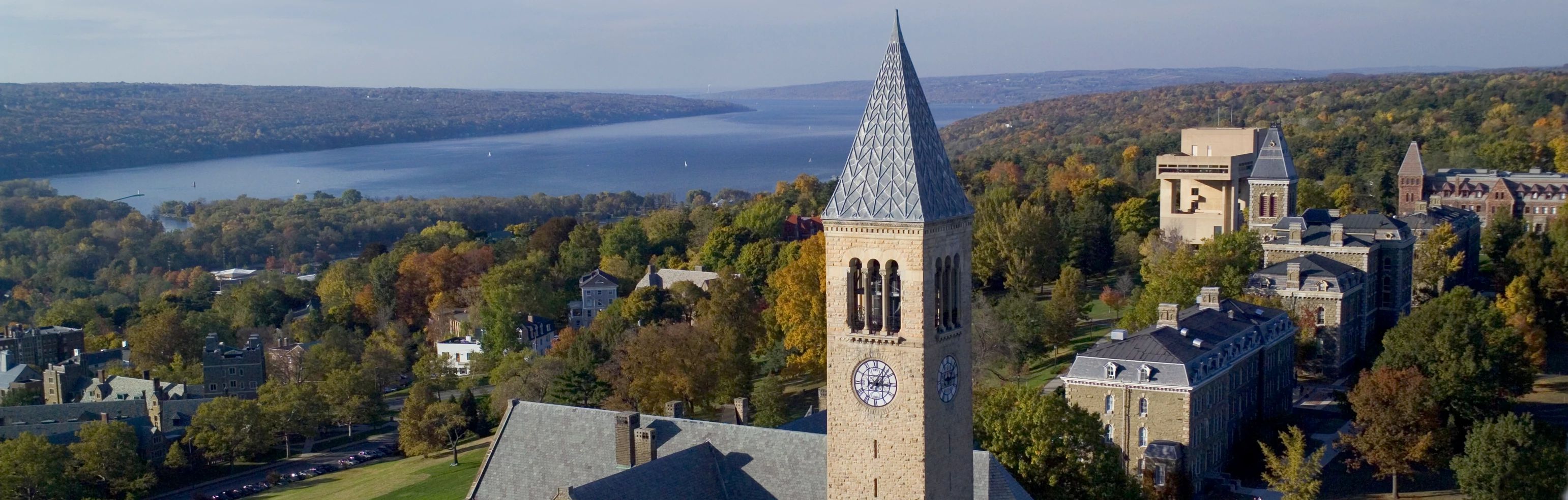 Central campus with McGraw Tower and Cayuga Lake in fall, from the air.
