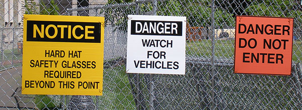 construction signs on fence