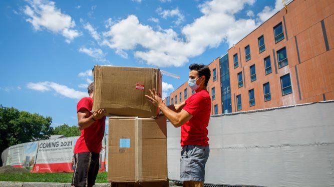 students with packing boxes