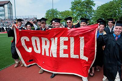 Cornell Graduates Holding Cornell Banner